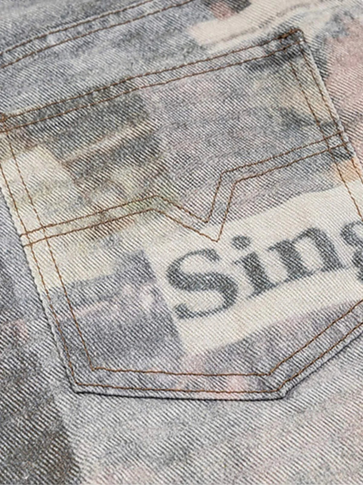 Loose-fitting jeans with newspaper and graffiti print