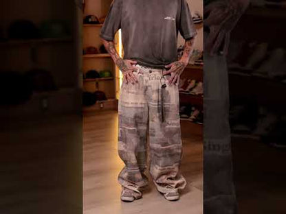Loose-fitting jeans with newspaper and graffiti print